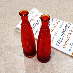 Set of two burnt orande-red glass flower bud vases.